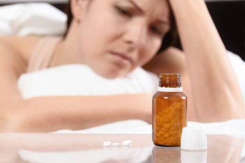 Woman taking antidepressant pills to lose weight